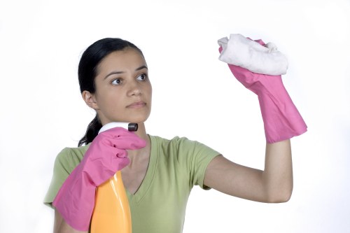 Technician performing carpet cleaning in an office